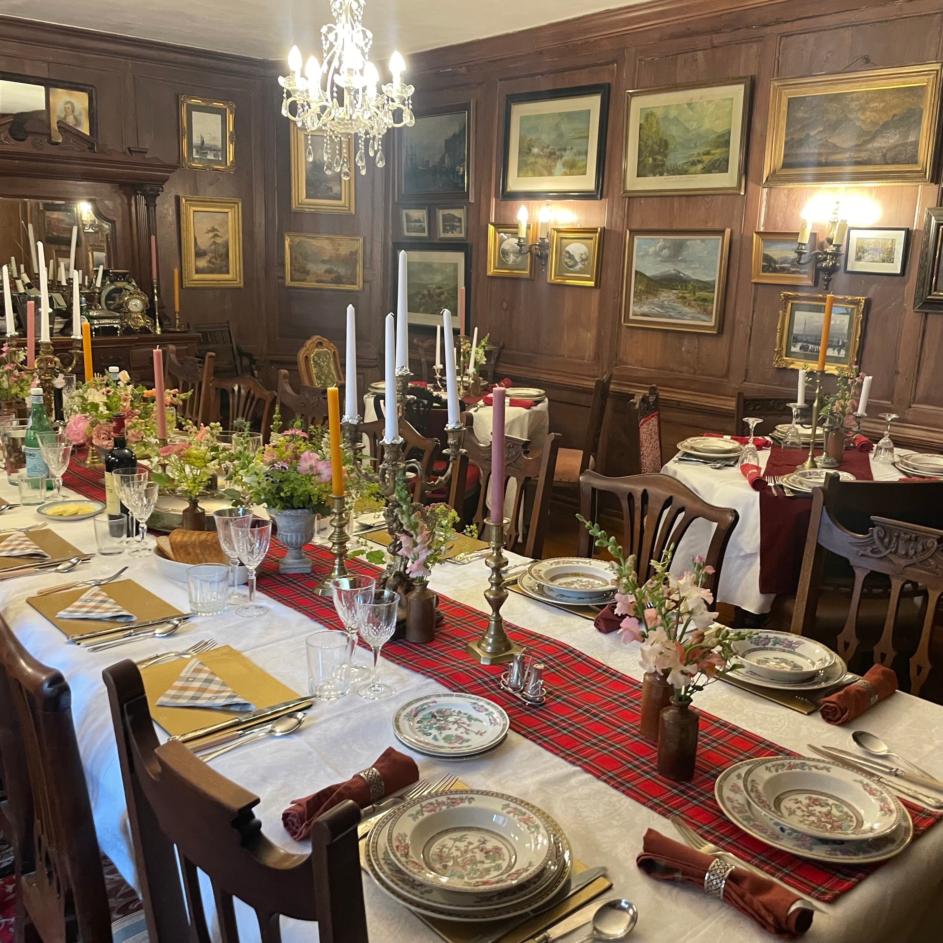 A candlelit dining room dressed for an Italian wedding banquet at a Scottish castle